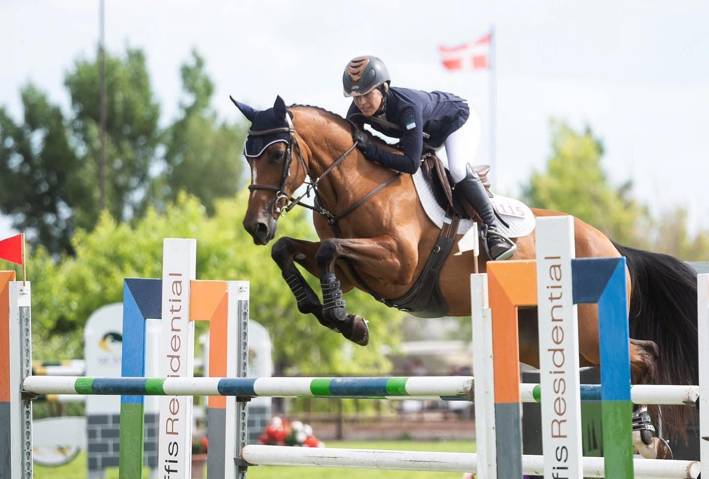 Horse and rider jumping over an obstacle in competition